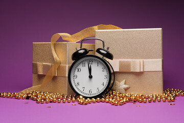 Alarm clock, Christmas gifts and decorations on color background