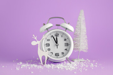 Alarm clock, Christmas decorations and snow on color background