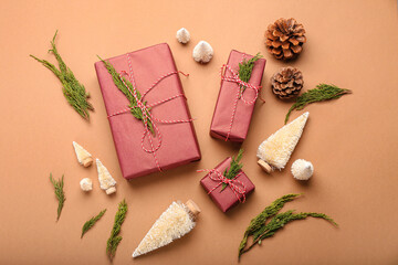 Fototapeta na wymiar Composition with Christmas gifts, coniferous branches and decor on color background