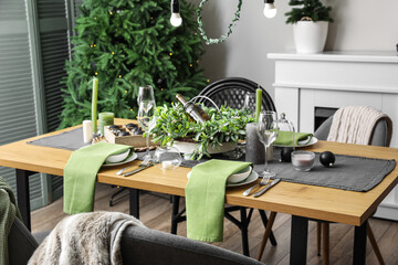 Dining table with beautiful setting for Christmas celebration in festive room