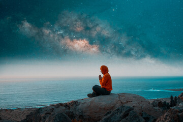 person meditating at night on top of the mountain under the Milky Way and shooting star