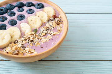 yogurt or yoghurt smoothie bowl with blue berry, banana and granola