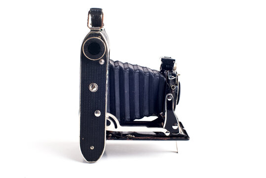 Vintage folding bellows roll film camera on white background