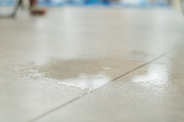 Water drips onto the tiled floor.
