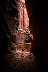Woman Heads into Tall Slot Canyon in Utah