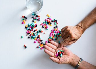 Closeup of hands taking pills health treatment isolated