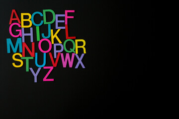 Colorful wooden english letters A-Z on black background