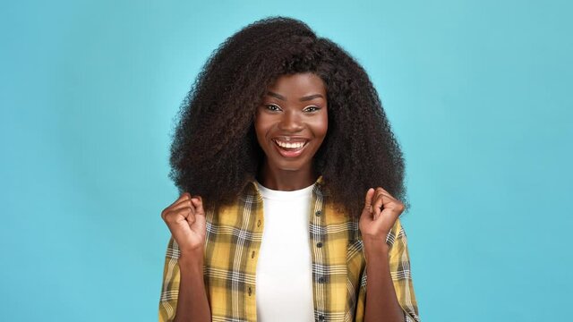 Ecstatic lady fists up shout yeah licky winner isolated blue color background