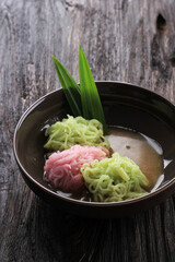 Putu Mayang or Petulo, Indonesian Traditional Javanese Snack Made of Rice Flour Strands Curled up into a Ball with Food Coloring, Served with Coconut Milk and Palm Sugar Syrup.