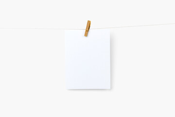 Blank photos hanging by wooden clip