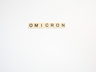 Omicron Spelled Out with Off White Tiles and Black Letters on White Background