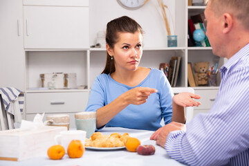 Obraz na płótnie Canvas Unhappy woman quarrelling with her husband at home interior
