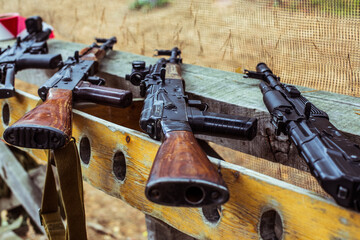 Various weapon models lie on the arms rack of the rifle landfill during military sports competition
