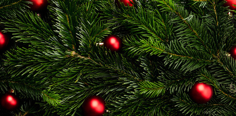Fototapeta na wymiar Evergreen fir branches with christmas balls. Christmas background. Shot from above.