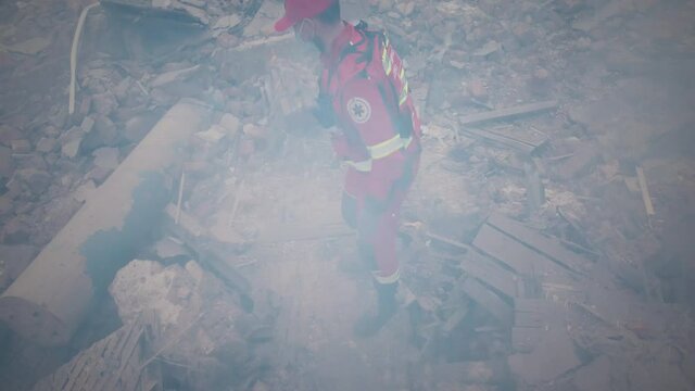 From above view of emergency service workers checking concrete rubble and searching for survivors while working on remains of broken building after earthquake