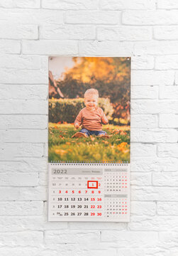 calendar with photo of child in front of white brick wall. printed products