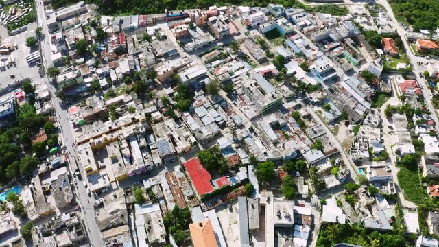 Quarters of dilapidated substandard and dysfunctional buildings. Sunny day in the slums of the big city. Houses made of metal plywood cardboard and planks.