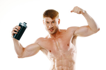 athletic man with pumped up muscular body sports drink light background