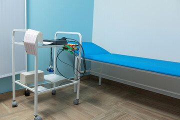 photo of an electrocardiograph printing out the results of a cardiogram during a doctor's appointment at the clinic