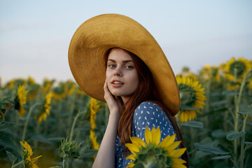 pretty woman with hat in the field of sunflowers freedom nature