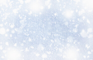 Beautiful winter background of snow and blurred forest in background, Gently falling snow flakes against blue sky, free space for your decoration. for your decorations. Wide panorama format.