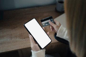 Young woman holding credit card and shopping online with smart phone.