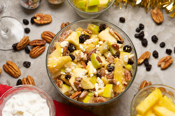 Apple salad with walnuts for Christmas on a gray background