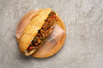 Philly cheese steak with bell pepper on gray background