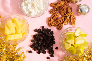 Ingredients for Christmas apple salad on a pink background