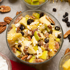 Apple salad with walnuts for Christmas on a gray background