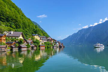 Fototapeta na wymiar Hallstatt, Austria - A scenic picture postcard view of the famous village of Hallstatt reflecting in Hallstattersee lake in the Austrian Alps.