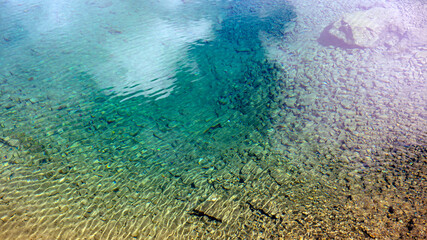 The lake with crystal clear water created by melting snow on the top of the mountain. North Caucasus.