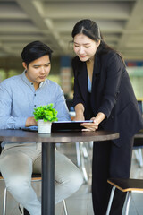 Two business people working together on a marketing project