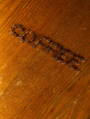 Coffee inscription on a wooden table. Vertical snapshot.