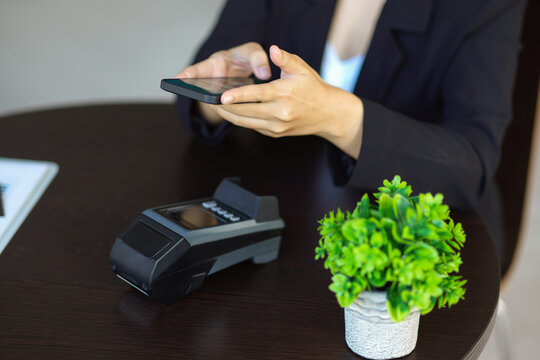 A female using smartphone to scan QR code on terminal machine