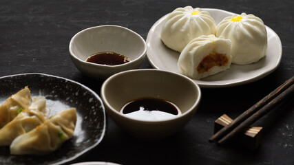 Pork buns and steamed Chinese dumpling with soy sauce