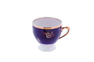 Ceramic blue cup with floral gold ornament isolated on white background