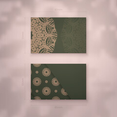 Business card in green color with abstract brown ornament for your business.