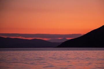 red sunset over the sea and mountains