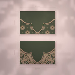Business card in green color with luxurious brown ornament for your business.