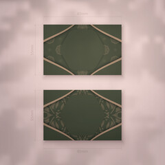 Business card in green color with luxurious brown pattern for your contacts.