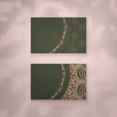 Business card in green color with vintage brown ornament for your contacts.