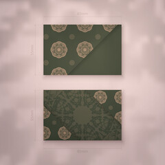 Business card in green with abstract brown ornament for your brand.
