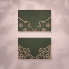 Business card in green with brown mandala pattern for your business.