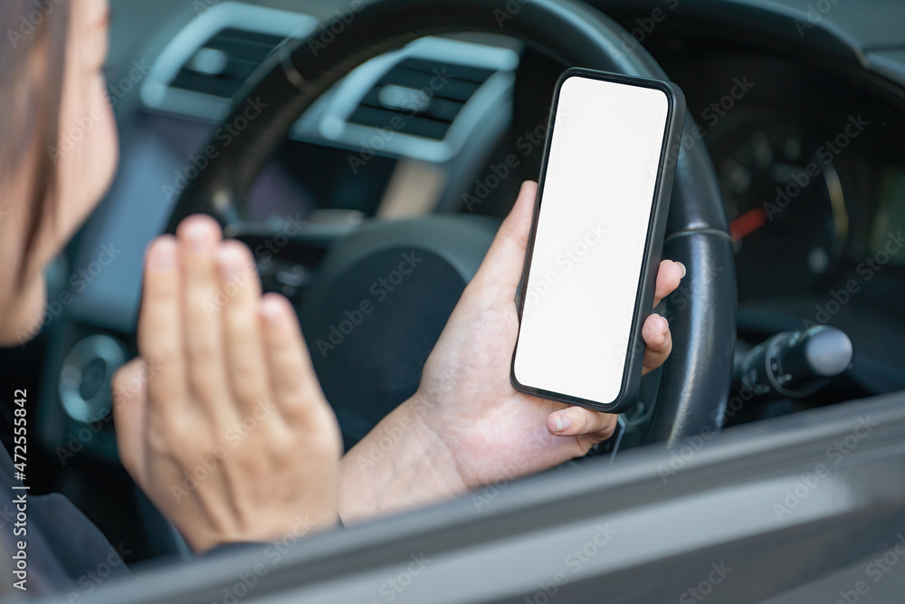 Poster female hand using smartphone in a car. smartphones in-car use for navigate or gps. mobile phone with