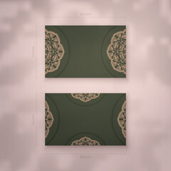 Business card in green with luxurious brown ornaments for your personality.