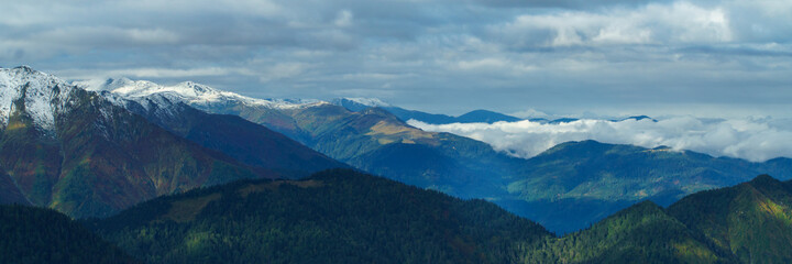 Aerial view above the clouds in mountain valley at morning. Wide banner