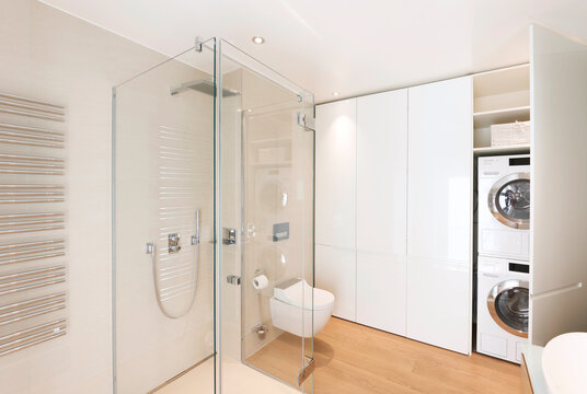 White Luminous Laundry Room With A Glass Shower