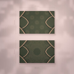 Business card in green with vintage brown ornament for your personality.
