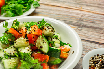 Mediterranean salad with tomatoes, cucumber, coriander, onions, olive oil and lemon in a white ceramic plate. Healthy vegetarian food, oriental and Mediterranean cuisine. Top view. Copy space. No.11